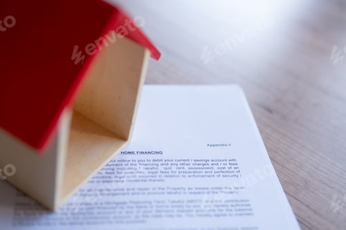 Preview: Closeup image of toy house and home financing offer letter from bank.