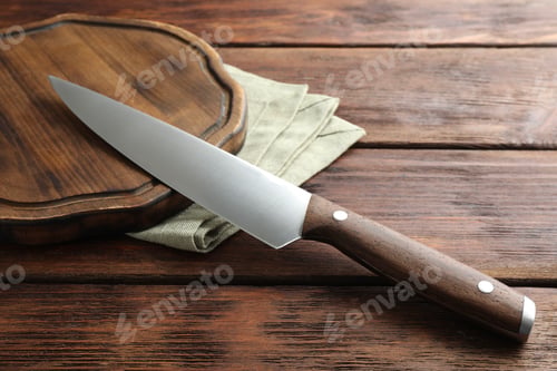 Preview: One sharp knife and board on wooden table, closeup