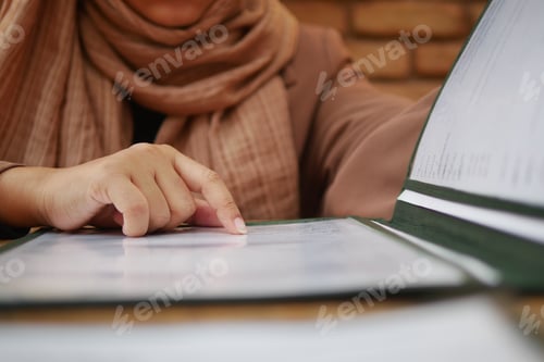 Preview: women hand reading a food menu at cafe.