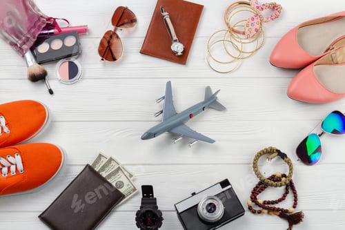 Preview: Flat lay mens and womens accessories and toy plane.