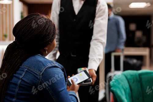 Preview: Tourist paying with phone in hotel