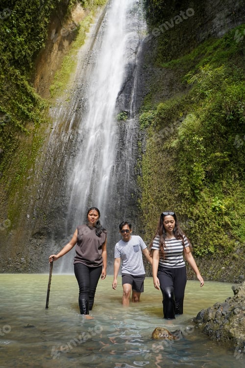Preview: small group of happy young asian people exploring waterfall
