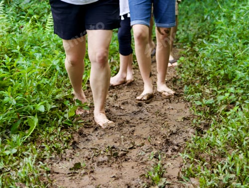 Preview: Mom and two children walking barefoot in mud