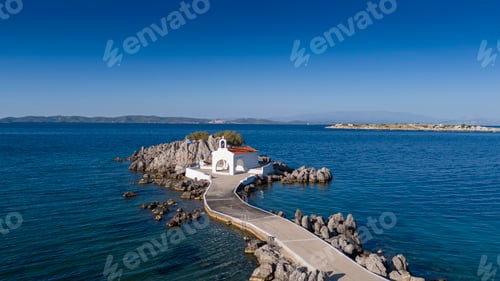 Preview: Little church of Agios Isidoros in the sea over the rocks, Chios island, Greece.