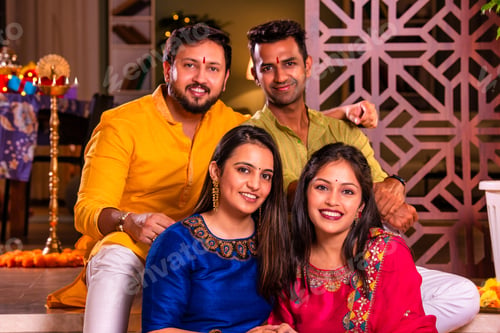 Preview: Cheerful Indian couples and friends celebrating Diwali at home with drinks, sweets, taking selfies