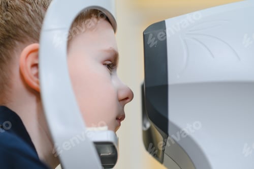 Preview: Child patient undergoing vision diagnostics with modern equipment in ophthalmology clinic
