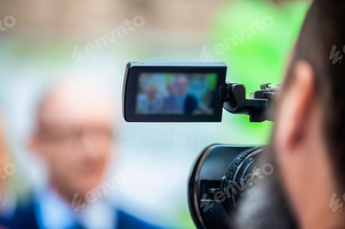Preview: Press Conference Outdoors. Cameraman at a Media Event
