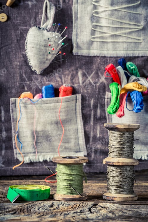 Preview: Colored threads and needles in sewing workshop