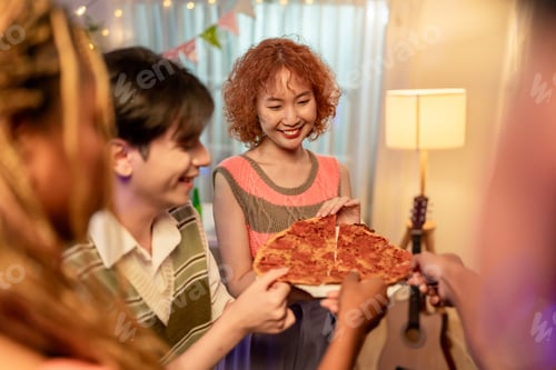 Preview: Group of diverse Generation Z friends enjoying a party in cozy house.