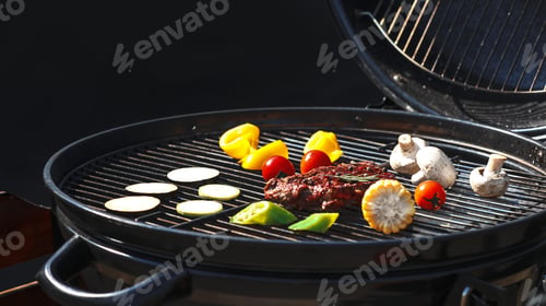 Vista previa: Sabrosos filetes y verduras en una moderna parrilla de barbacoa