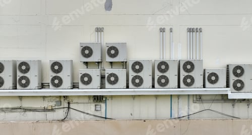 Preview: Many condensing units of air conditioners are installed on concrete building wall. Air conditioner