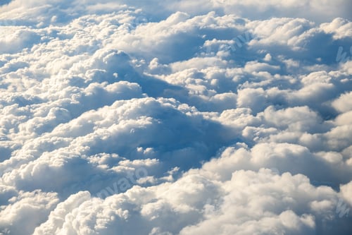 Preview: Aerial view of white puffy clouds viewed from an airplane.