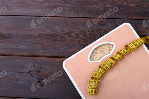 Preview: Scales and measure tape on the wooden floor