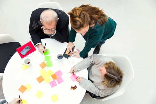Preview: Brainstorming session with colorful sticky notes on a white table.