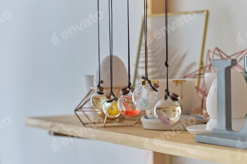 Preview: wall shelf with interior details. in the foreground pendant with a colorful flower inside.