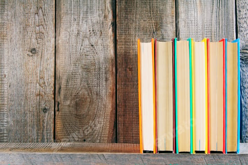 Preview: Books on a wooden shelf.
