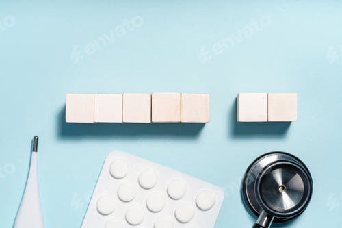 Preview: Medical items and wooden blocks on light blue background