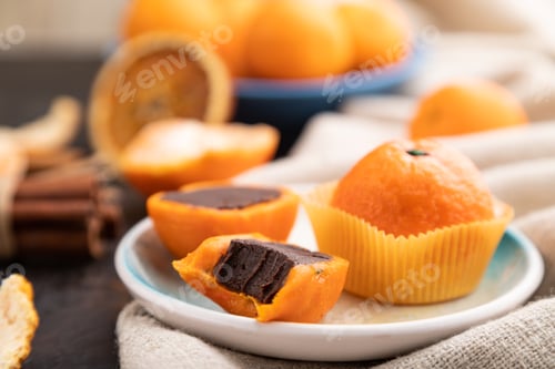 Preview: Truffle chocolate tangerine candies on a black concrete background. Side view, selective focus.