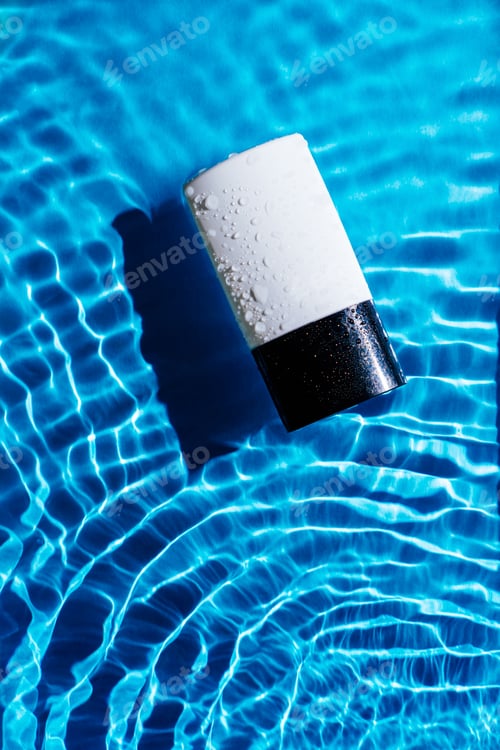 Preview: Fashion trendy bottle of perfume toilet water, lotion on blue wave splash background.
