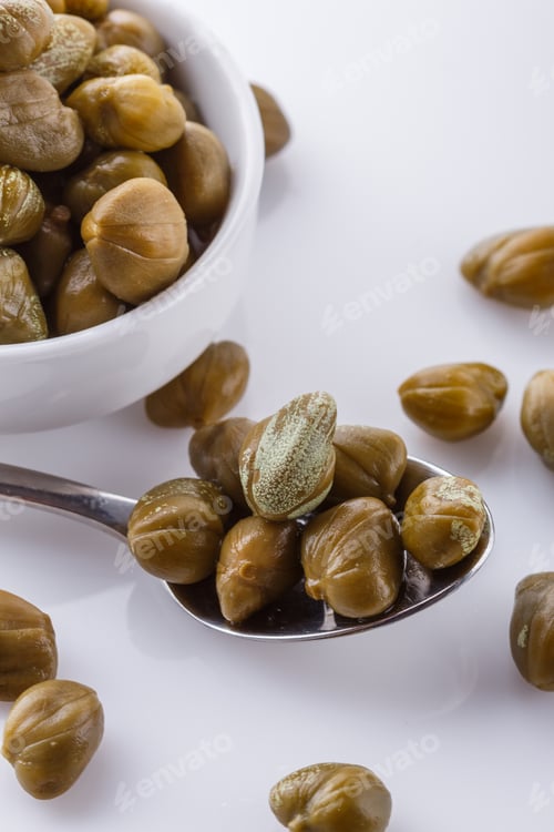 Preview: Pickled capers on a white acrylic background