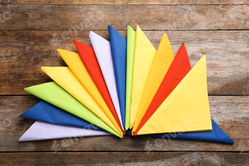 Preview: Colorful paper napkins on wooden background, top view