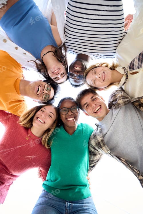 Preview: Portrait from below large diverse group friends posing hugging in circle looking smiling at camera.