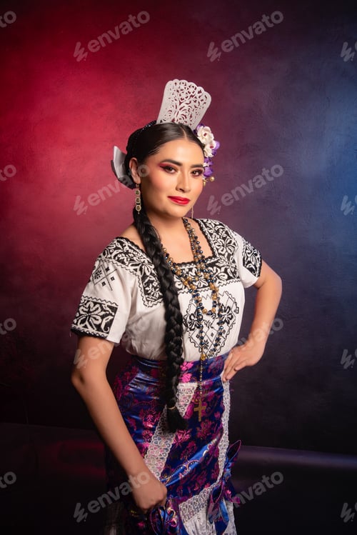 Preview: A woman in a traditional Mexican dress poses for a photo