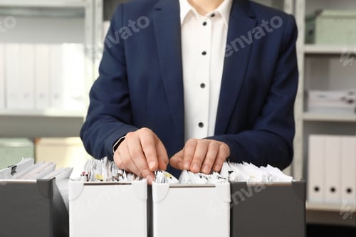Preview: Woman taking documents from folder in archive, closeup
