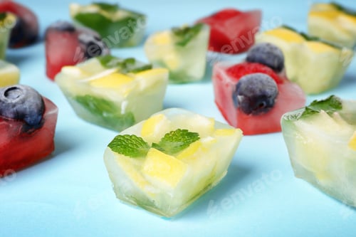 Preview: Fruit and berry ice cubes on color background