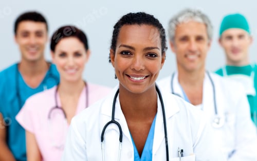 Preview: Attractive Female Doctor Standing Before Her Team