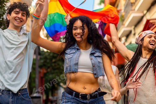 Preview: Happy multiethnic friends waving rainbow flag at lgbtq pride parade celebrating gay rights