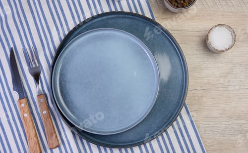 Preview: Empty round ceramic plate on the table with spices, top view