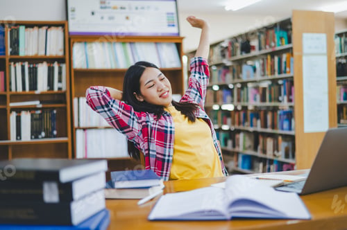 Preview: Students are relaxing after working on their laptops and searching for books