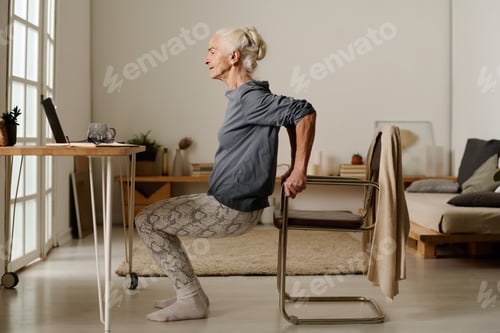 Preview: Woman doing squats in front of laptop
