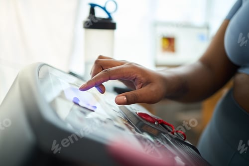 Preview: Hand of Woman Setting Up Treadmill for Exercise