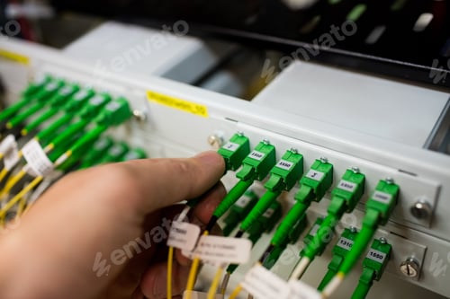 Preview: Technician plugging patch cable in a rack mounted server
