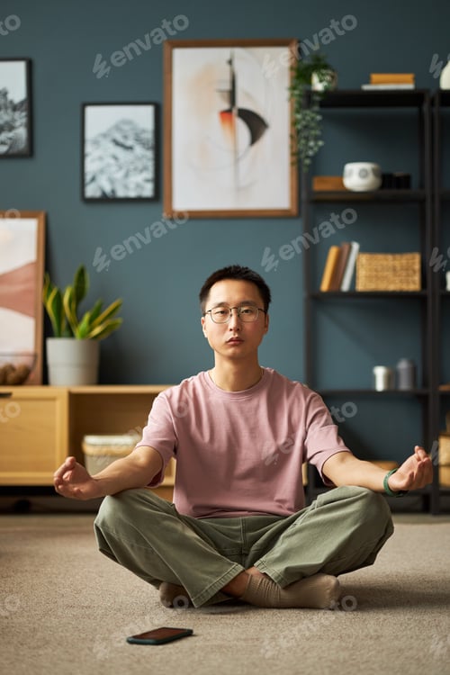 Preview: Portrait of Young Adult Asian Man Practicing Yoga Meditation Sitting Cross Legged