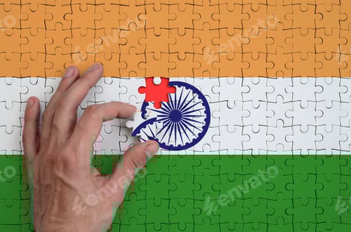 Preview: India flag is depicted on a puzzle, which the man's hand completes to fold.