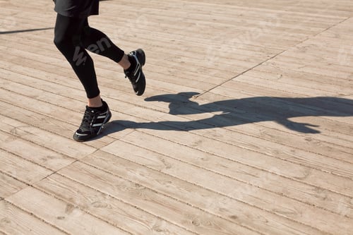 Preview: Legs of runner on wooden floor