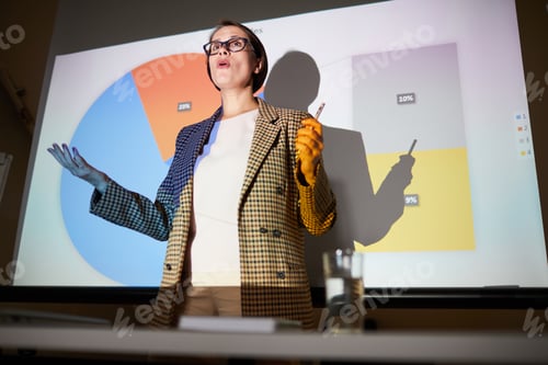 Preview: Confident lady explaining data on projection screen