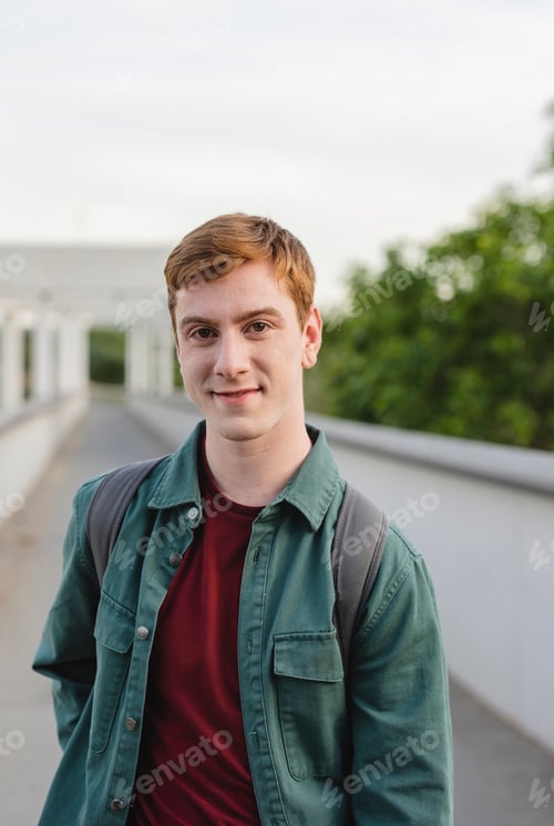 Preview: young redhead student boy with backpack outside, generation z, influencer