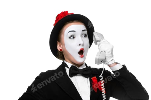 Preview: Business Woman As Mime Holding A Handset Isolated On White Background.Concept Of Wonder And