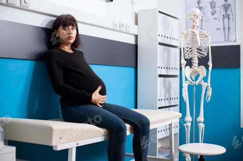 Preview: Pregnant woman looking at camera