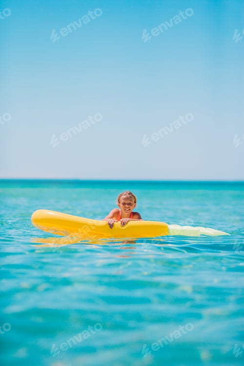 Preview: Adorable girl on inflatable air mattress in the sea