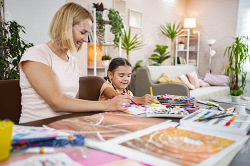 Preview: Mother and daughter engage in creative drawing during a playful afternoon at home