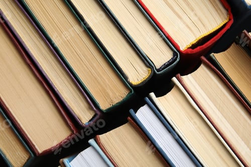 Preview: Many different hardcover books as background, top view