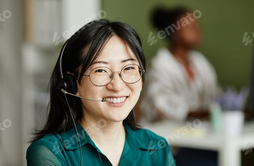 Preview: Asian female operator in headphones