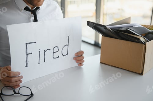 Preview: fired employee holding fired sign in hand