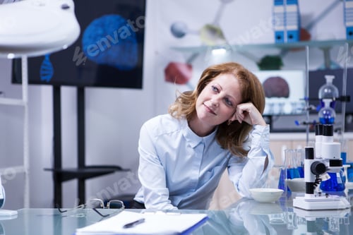 Preview: Middle age woman with red hair in a biomedical laboratory