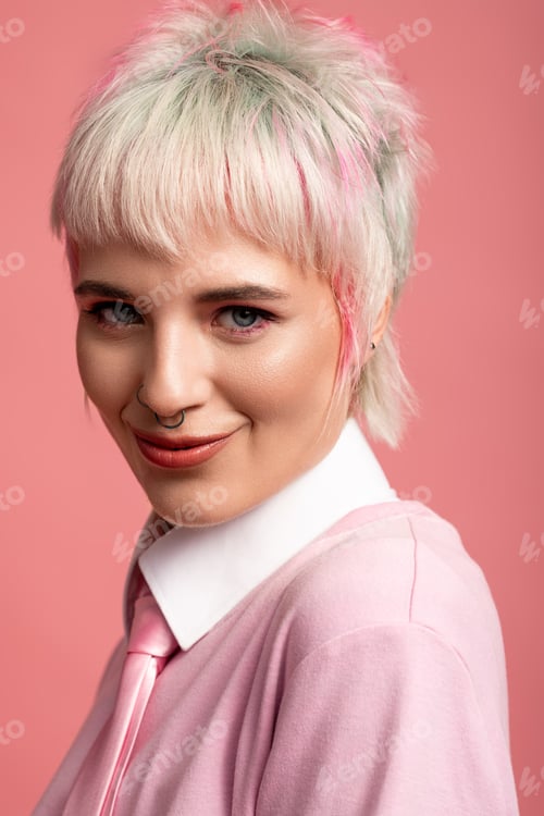 Preview: Young woman with vibrant hair and playful expression against a pink background